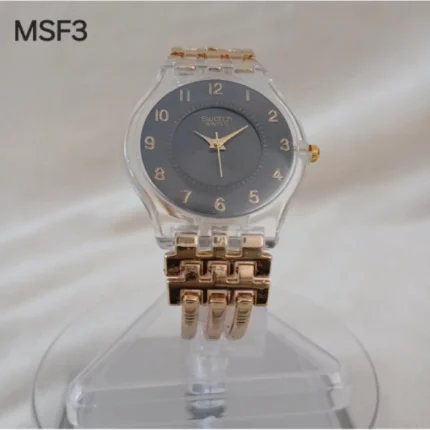 montre femme élégante swatch avec cadran transparent doré